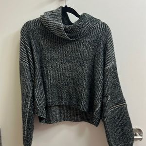 Chunky grey turtleneck with zippered sleeves and small wear
